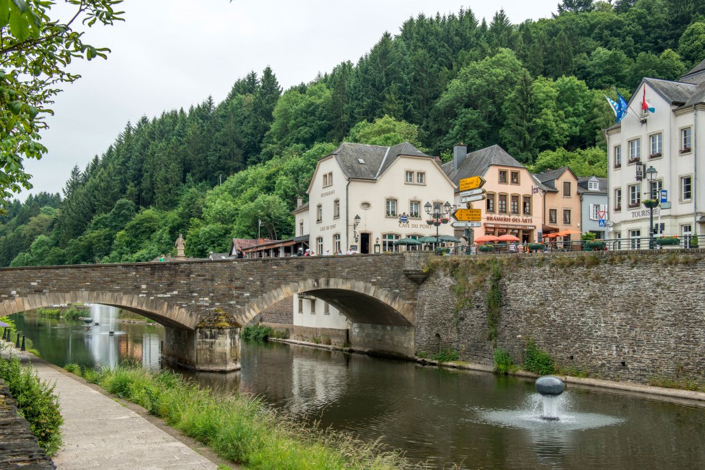 Scenic view of the river Our and the bridge in Vianden, featuring Café-Restaurant Du Pont, photographed by Marcel de Hoog.