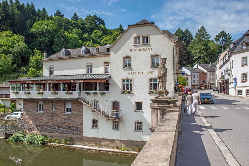 Side view of the Du Pont restaurant in Vianden, shot from the bridge railing across the river Our by Dutch photographer Marcel de Hoog.