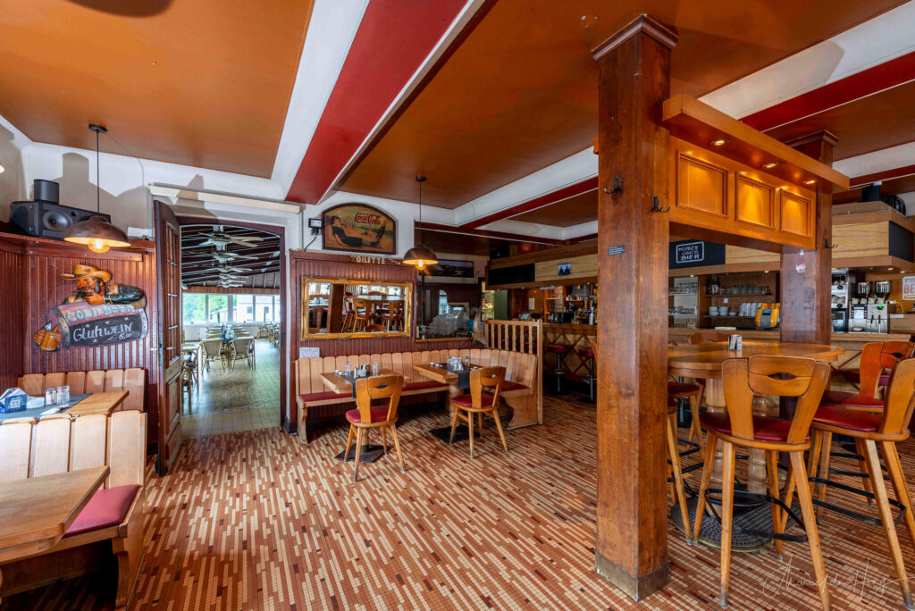 Interior view of the back of Café Du Pont in Vianden, showing the transition to the spacious restaurant area, taken by Marcel de Hoog.